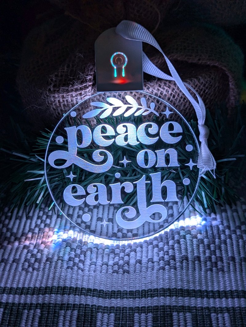 Engraved Peace on Earth LED bauble powered by rechargeable battery pod