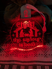 Laser-engraved Christ the Saviour is Born acrylic bauble displaying multi-colour LED lighting