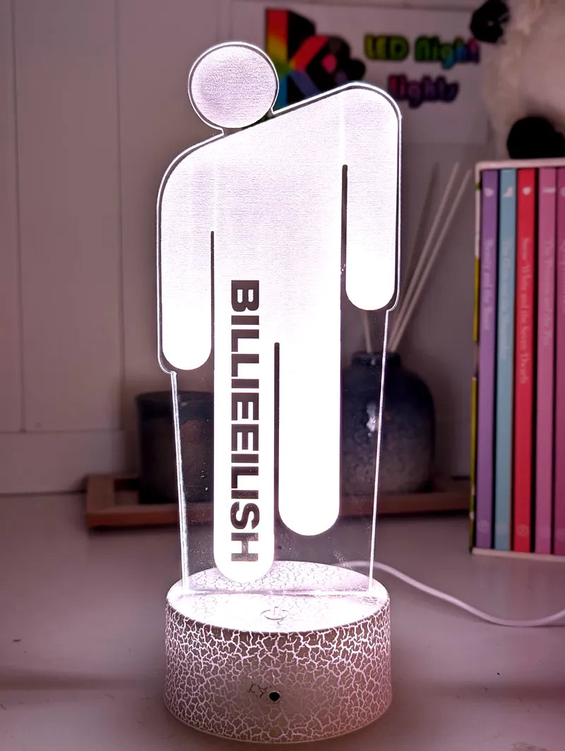 LED light shaped like a person with 'Billie Eilish' text on a cracked pattern base.