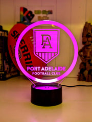Port Adelaide Power 3D LED night light glowing softly in a child’s bedroom with remote control.