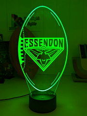 Essendon Bombers 3D LED night light glowing softly in a child’s bedroom with remote control.