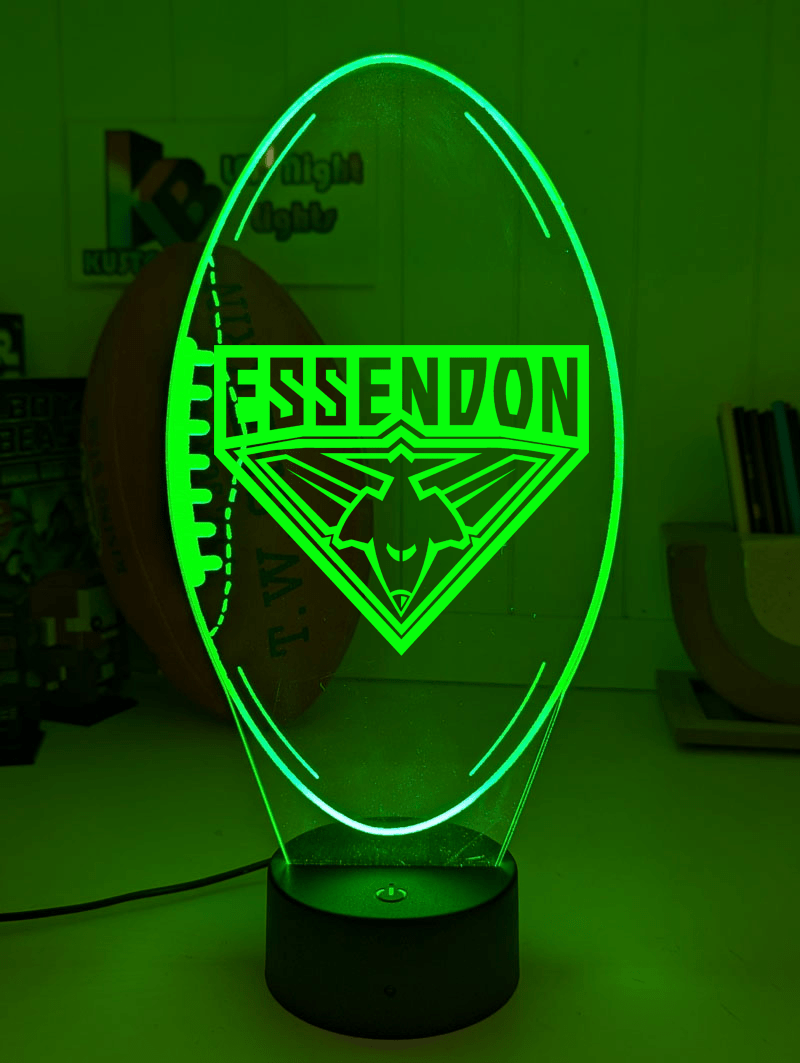 Essendon Bombers 3D LED night light glowing softly in a child’s bedroom with remote control.
