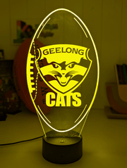 Geelong Cats 3D LED night light glowing softly in a child’s bedroom with remote control.