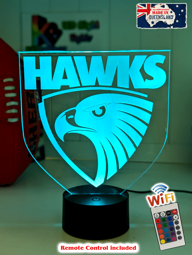 Hawthorn Hawks 3D LED night light glowing softly in a child’s bedroom with remote control.