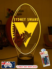 Sydney Swans 3D LED night light glowing softly in a child’s bedroom with remote control.
